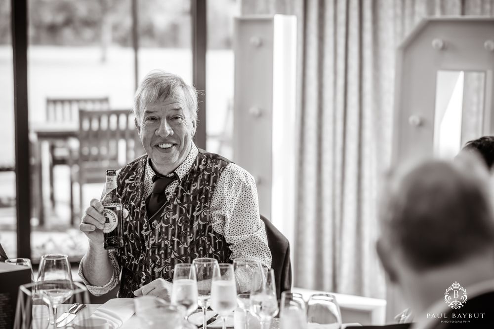 Black and white photo of a guest enjoying a moment during a wedding reception.