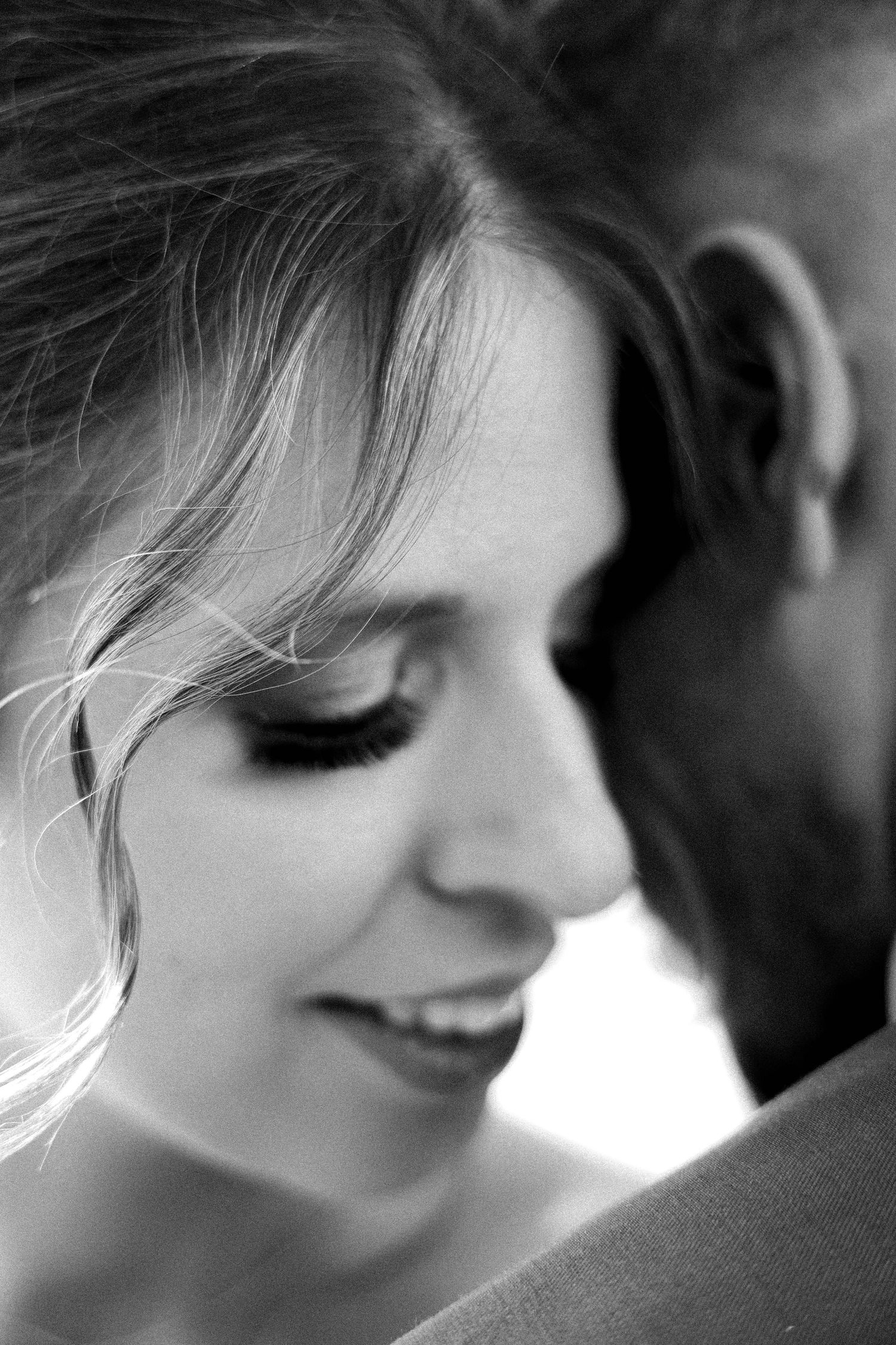 Intimate black and white portrait capturing tender romantic moment.