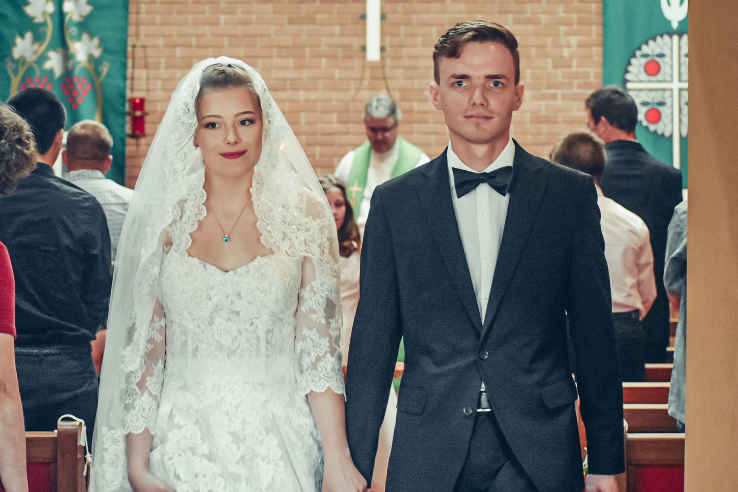 Traditional church wedding ceremony with formal attire and decor.