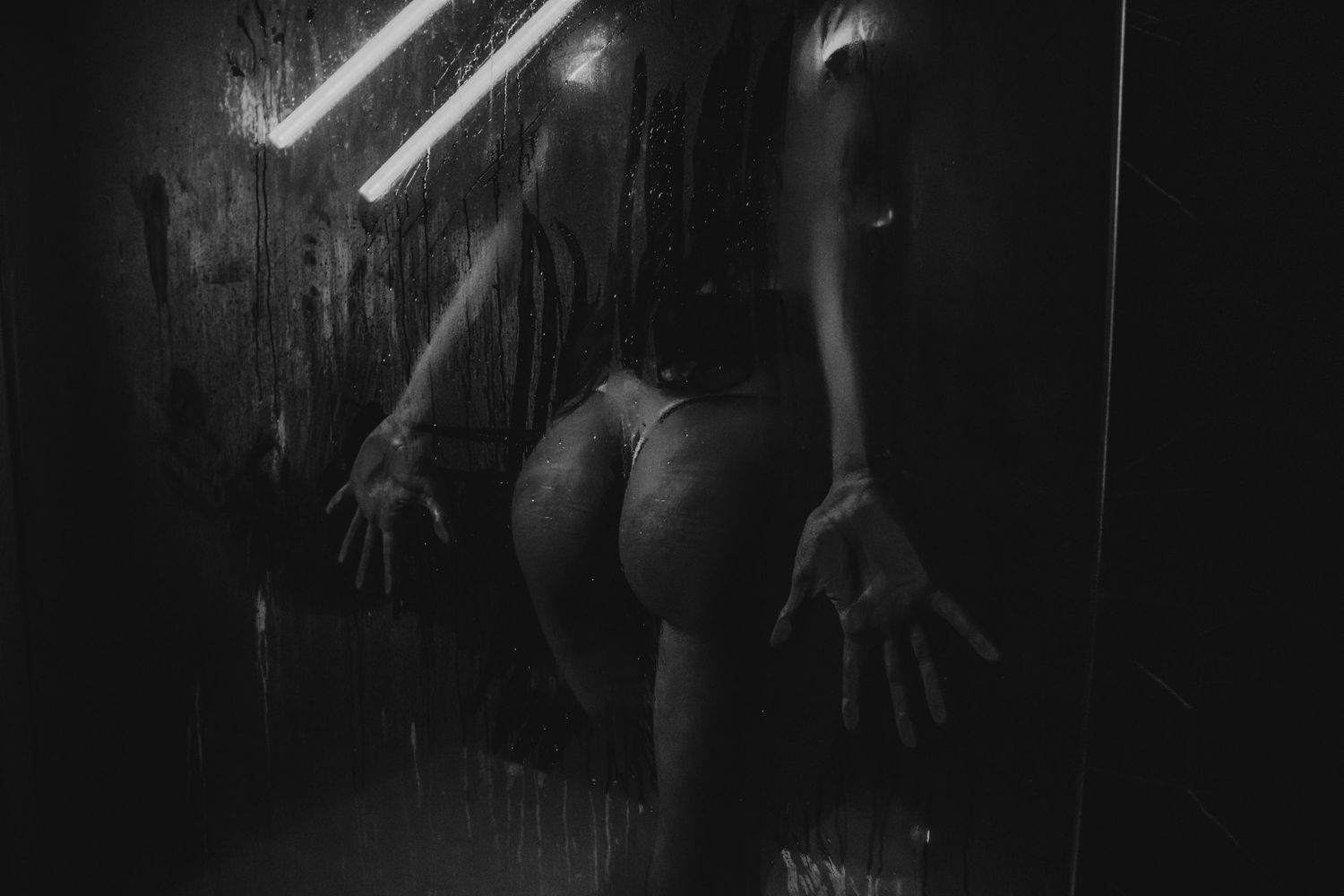 Mysterious black and white photograph with dramatic lighting and shadowy forms.
