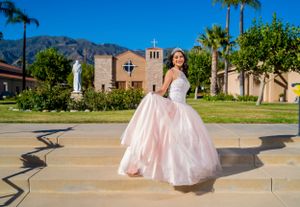 A twirling pose in a pink ballgown against Spanish colonial architecture and palm trees. sylmar.