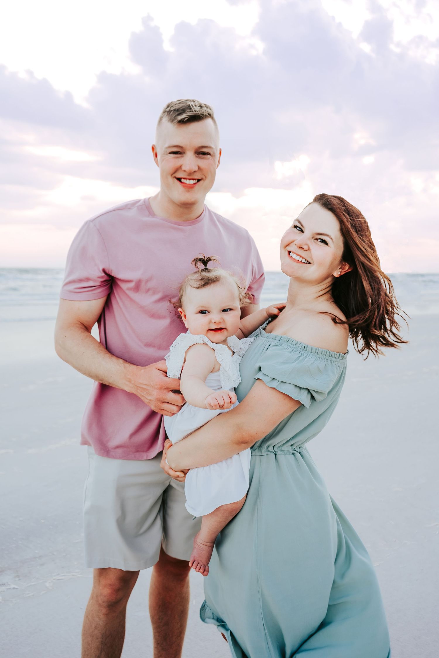 Outdoor Family Session at Indian Rocks Beach in Indian Rocks, FL; Parents holding baby on beach