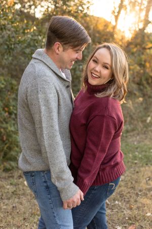Husband laughing at wife while she laughs at camera