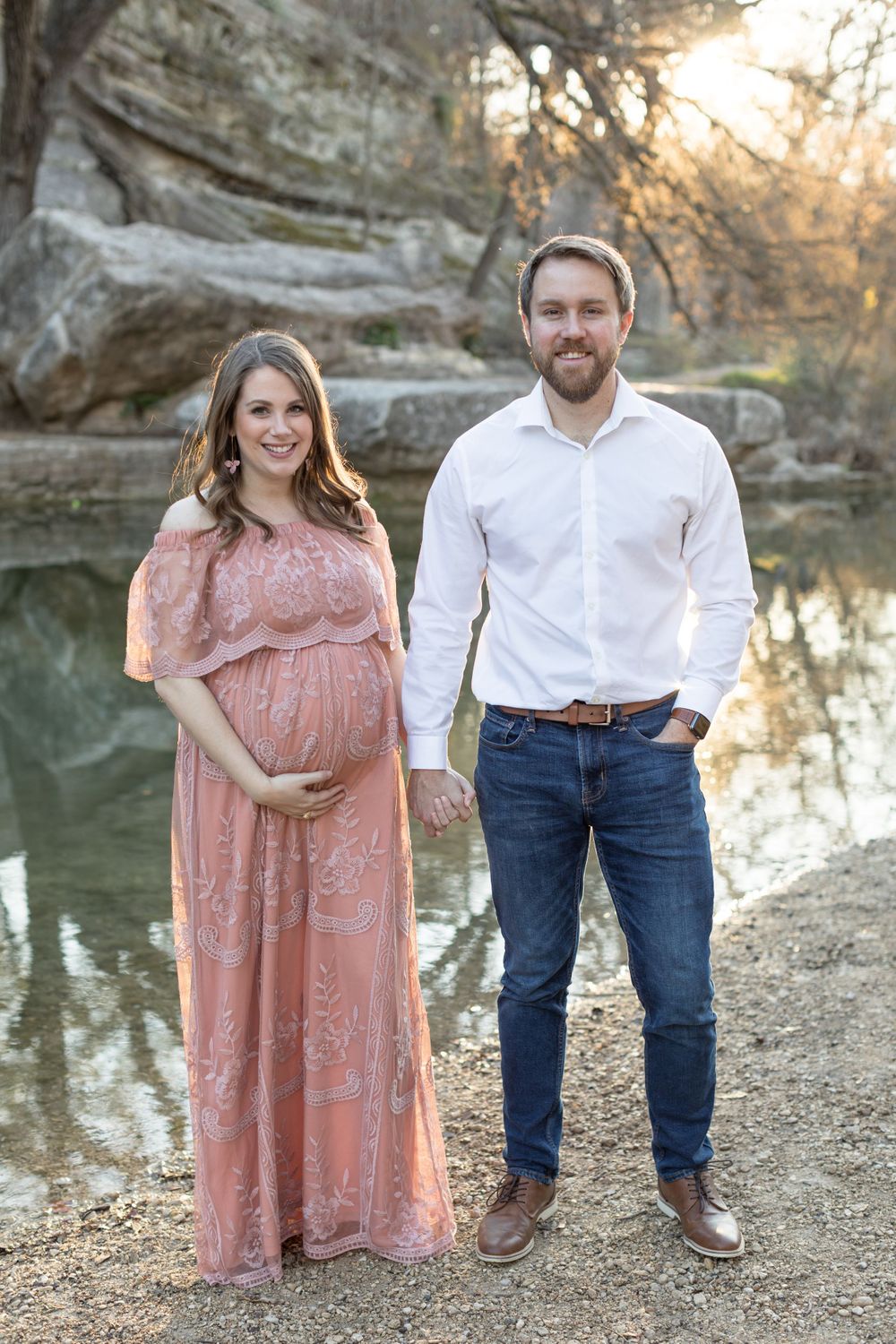 Couple with pregnant wife outdoors near river in Austin, Texas