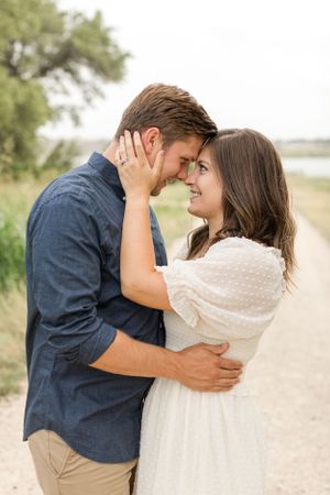 Couple with heads and noses touching, smiling at each other