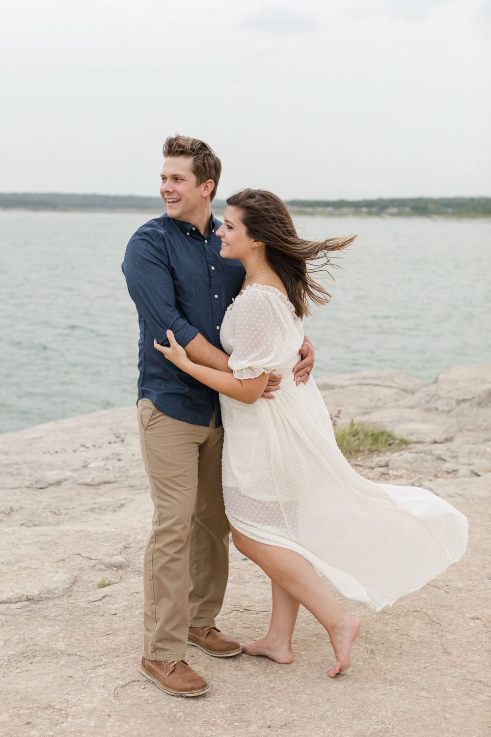 Couple looking off in the distance near lake in Georgetown, Texas