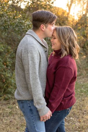 Husband lovingly kissing his wife's forehead