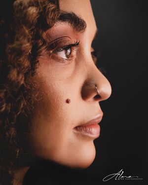 Dramatic side profile close-up showcasing defined features and natural makeup.