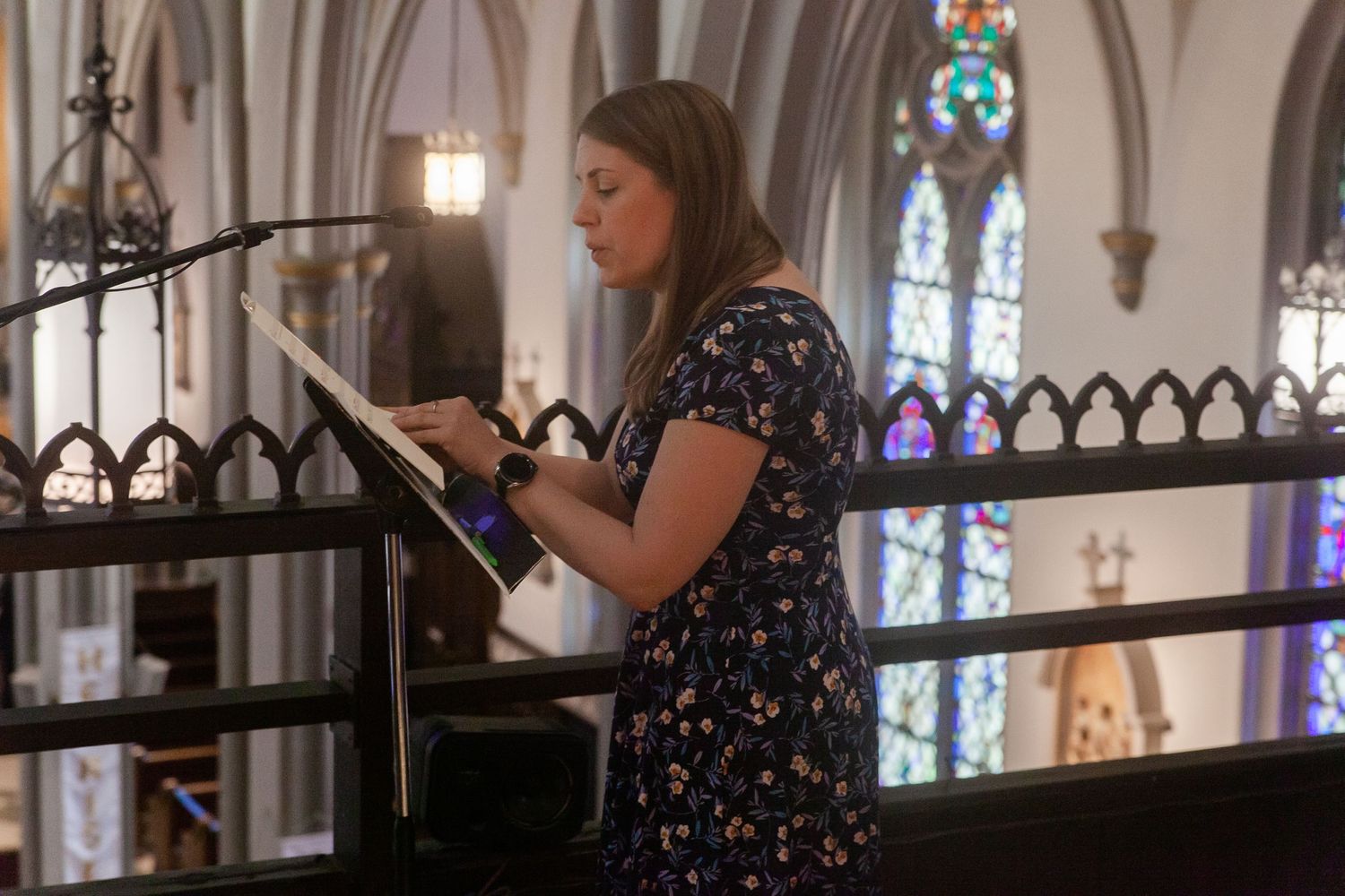 Cathedral wedding ceremony with elegant architectural details and stained glass windows.