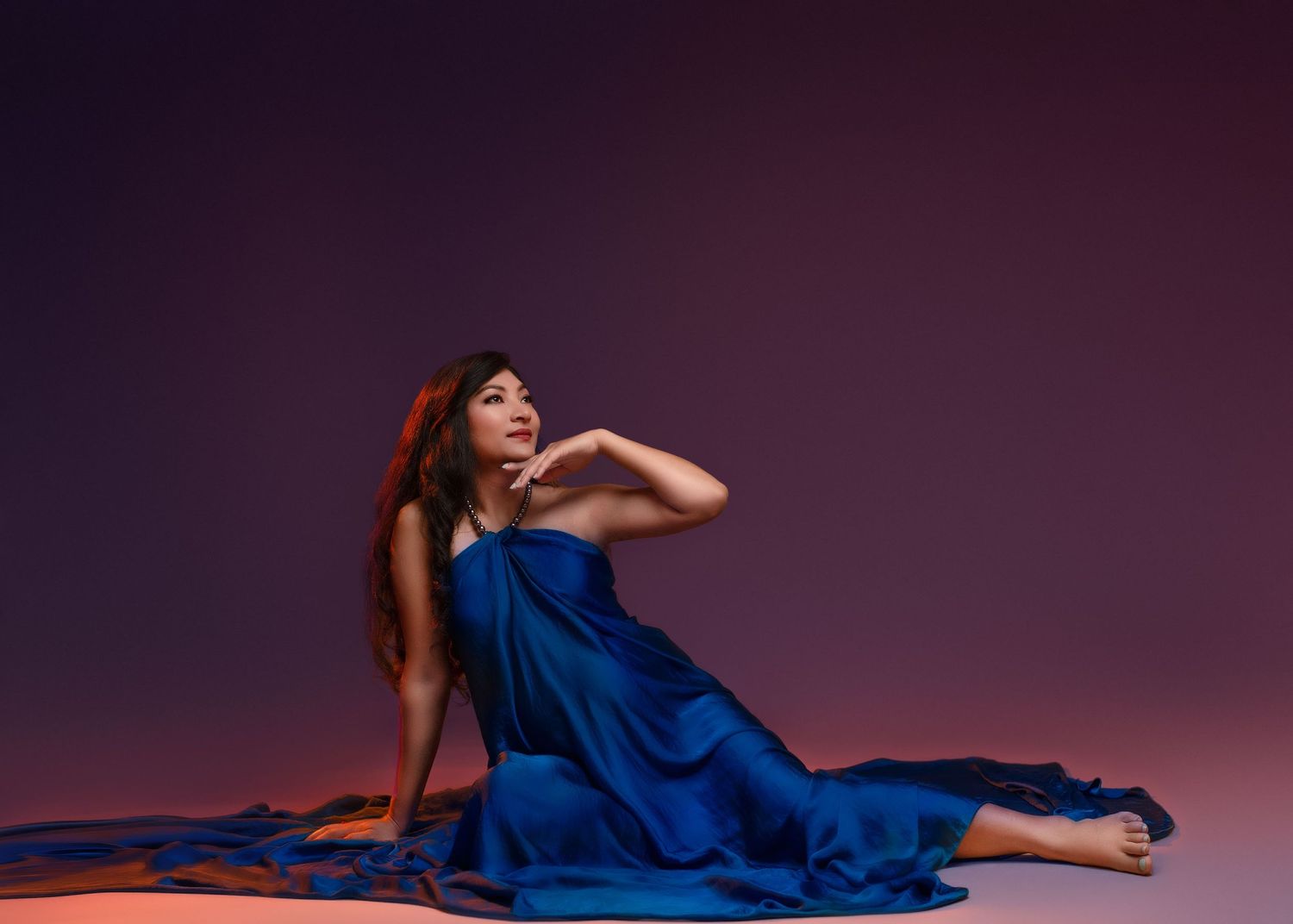 a minnesota maternity photographer captured an expecting mother laying on the floor in a colorful portrait