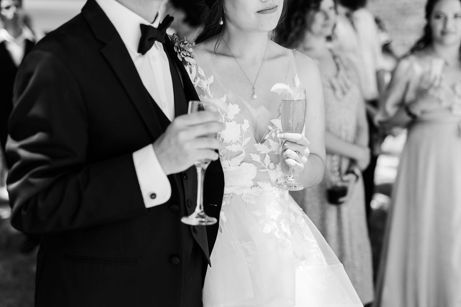 An elegant black and white photo of champagne glasses at a wedding celebration.