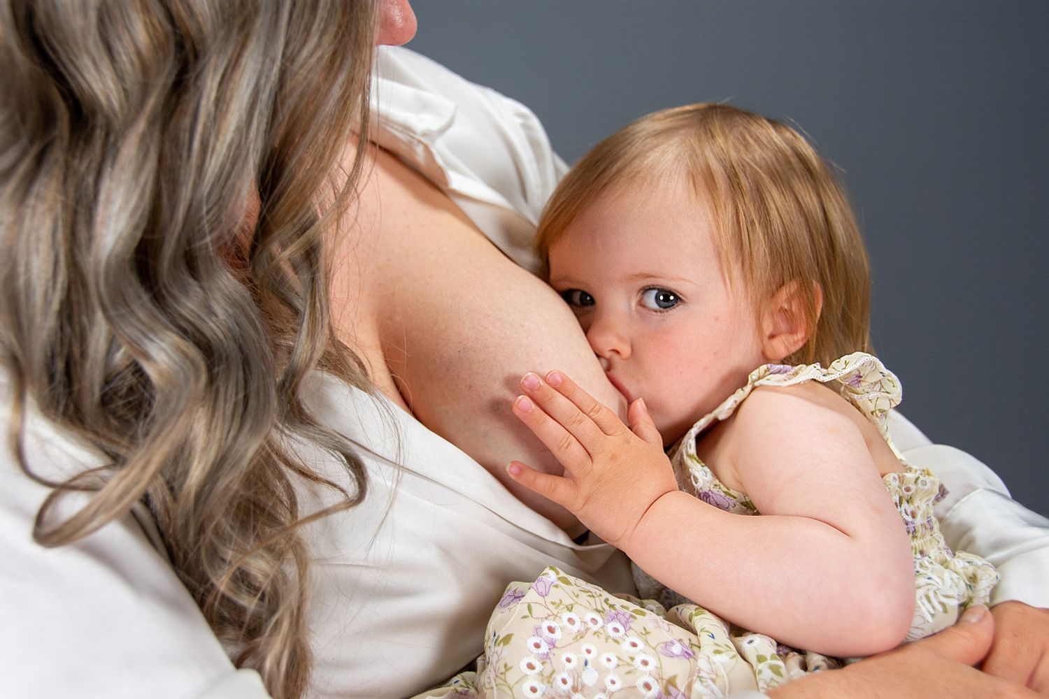 Professional Breastfeeding Photoshoot holding Mama