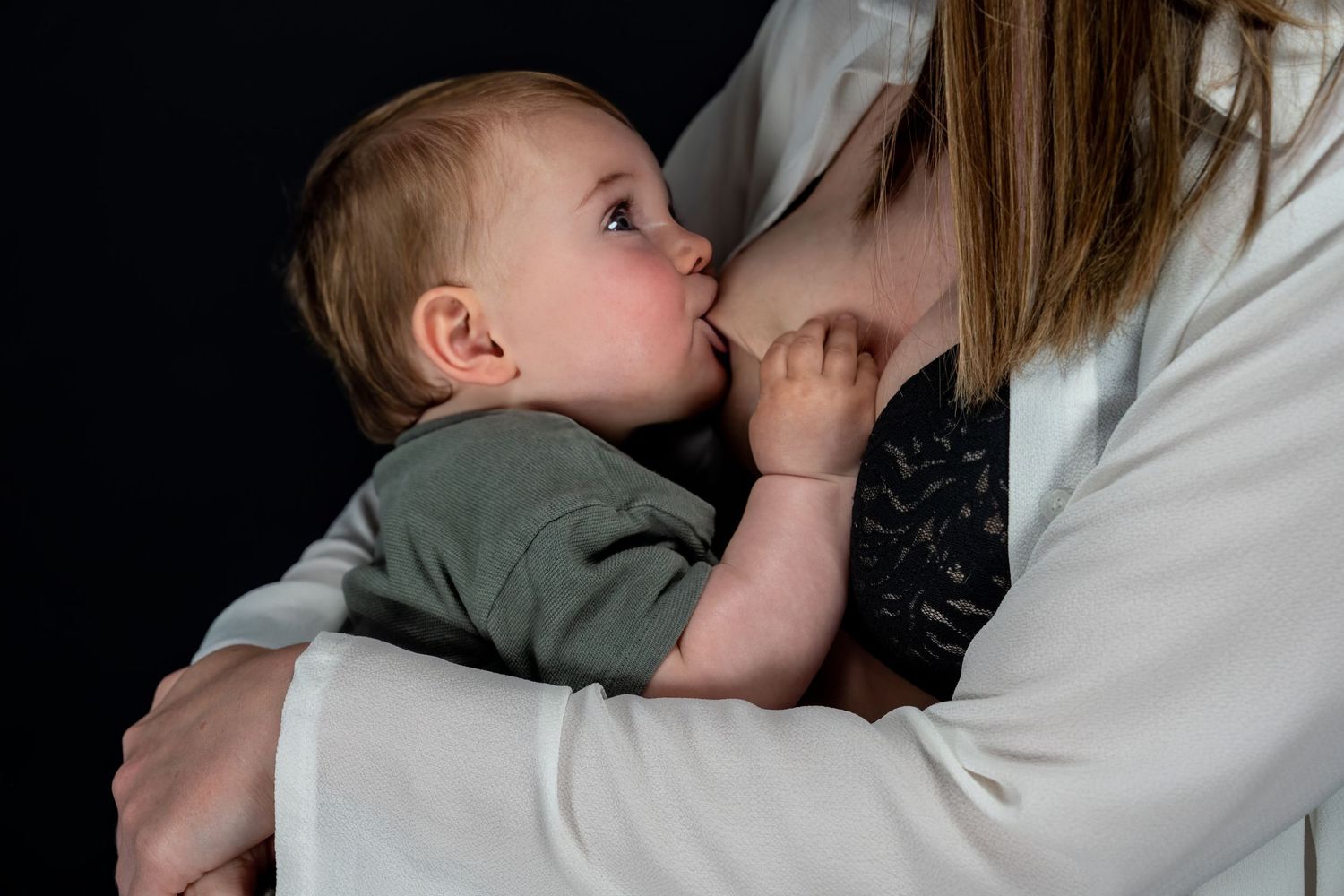 Professional Breastfeeding Photoshoot looking at Mama