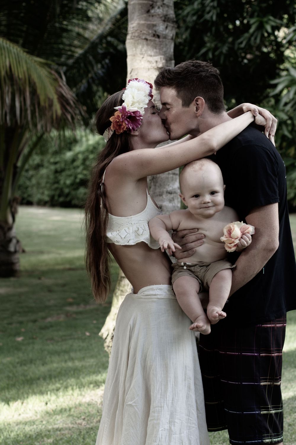 Couple kiss with little boy in cuddle, family photography, gorgeous family photography, family photos. Dorset family photo