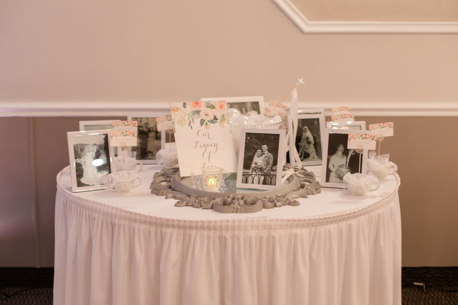 Elegant round banquet tables with white linens and formal place settings arranged for a wedding reception.