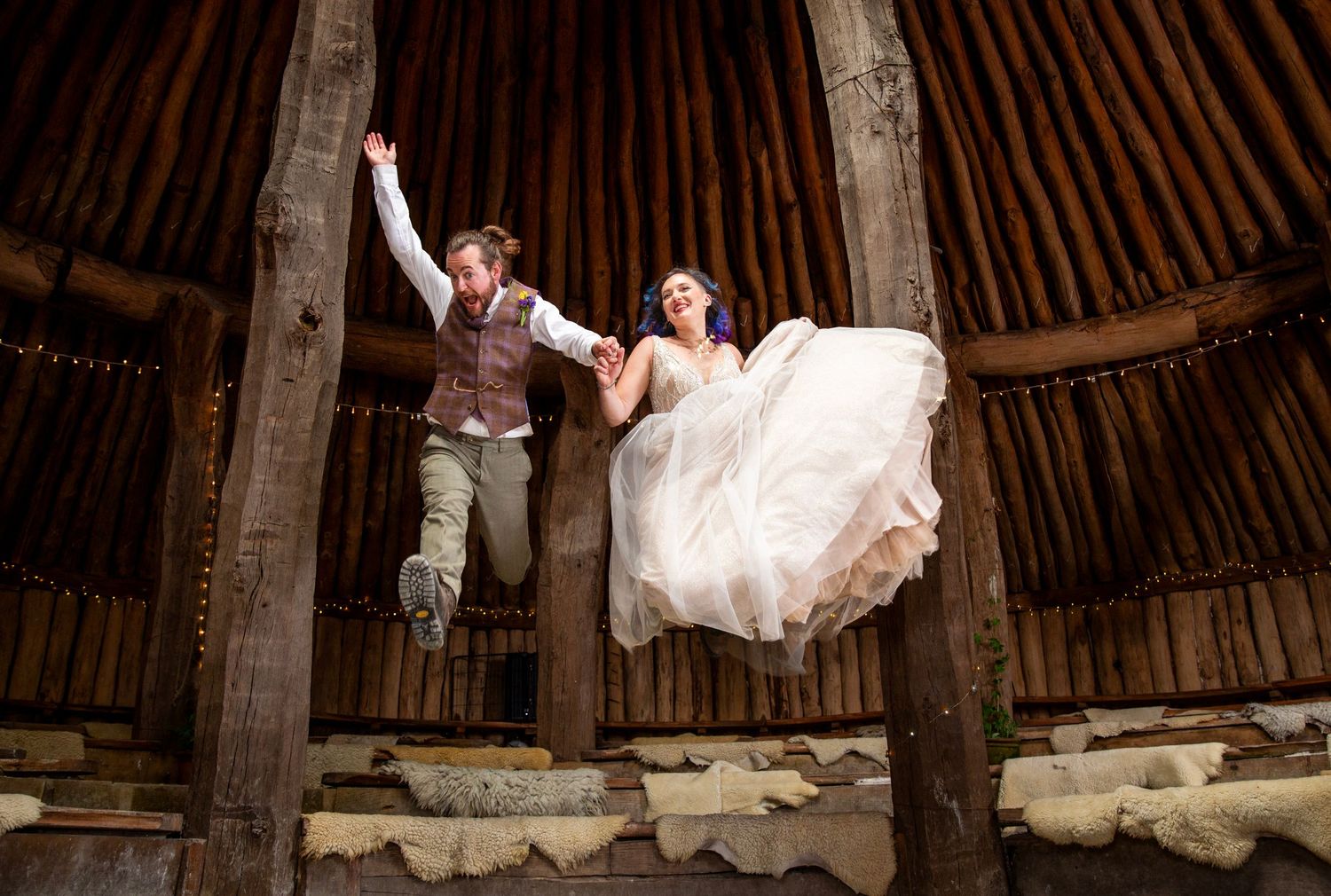 A flowing white dress spins in a circular motion inside a wooden barn structure with ambient lighting.