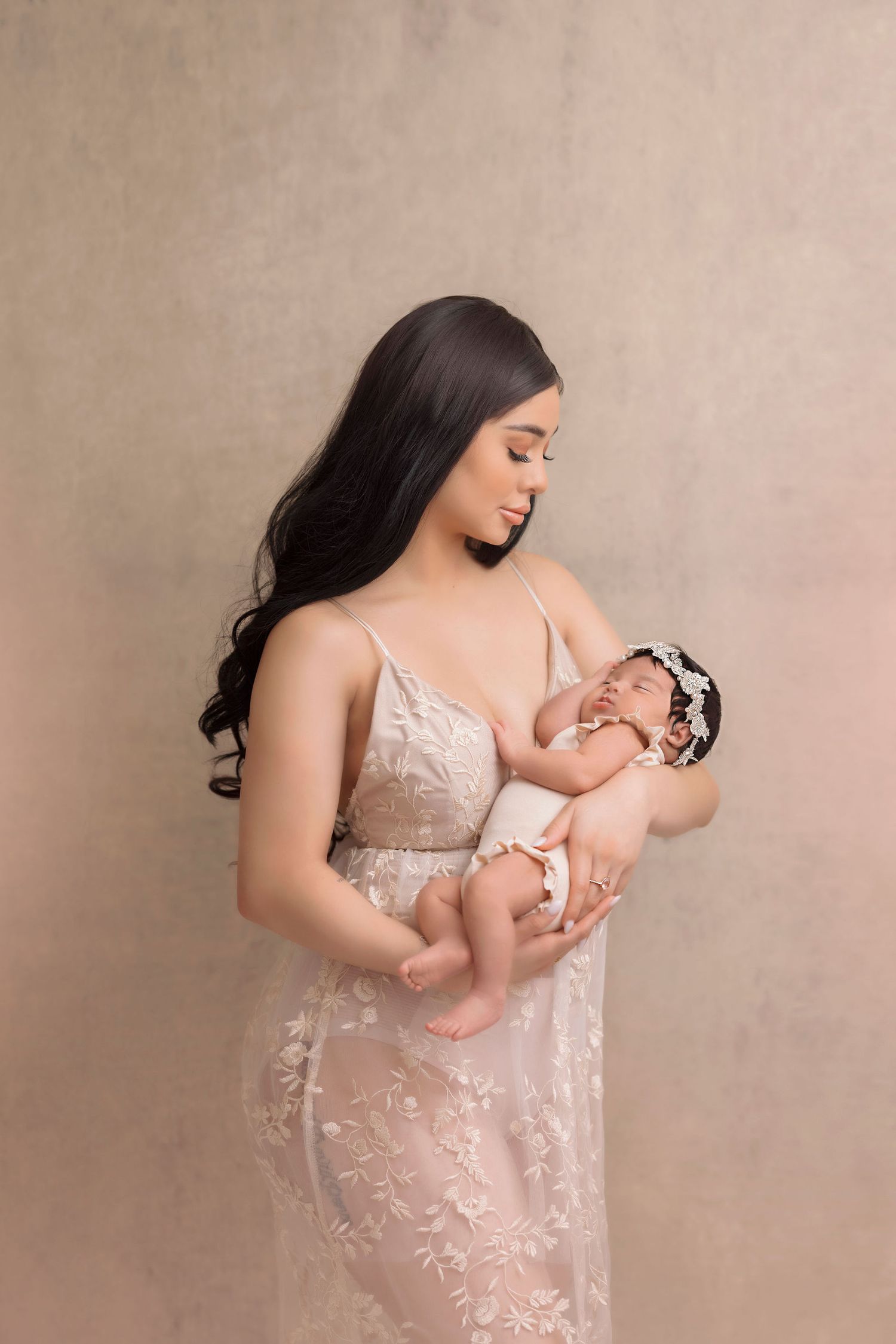 Tender moment captured in soft beige tones with lace dress details.