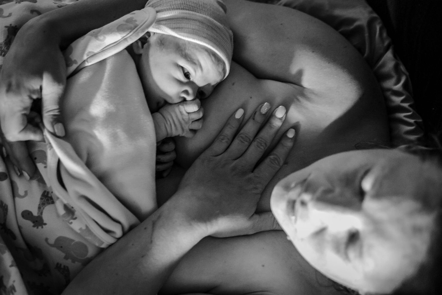 Mom holding her newborn just after birth in their home near Kingsley, IA.