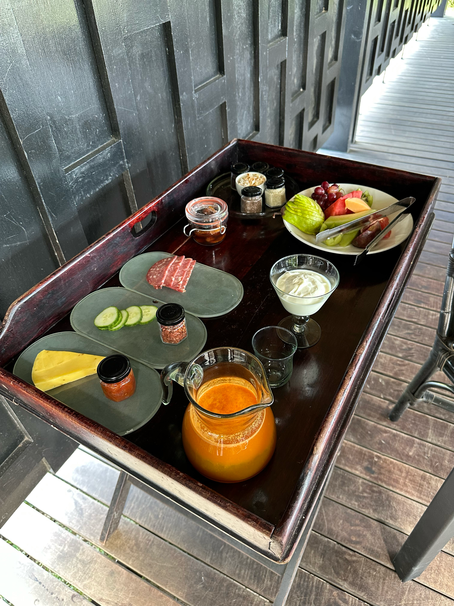 Craft cocktails and appetizers served on dark wooden trays with fresh citrus garnishes.