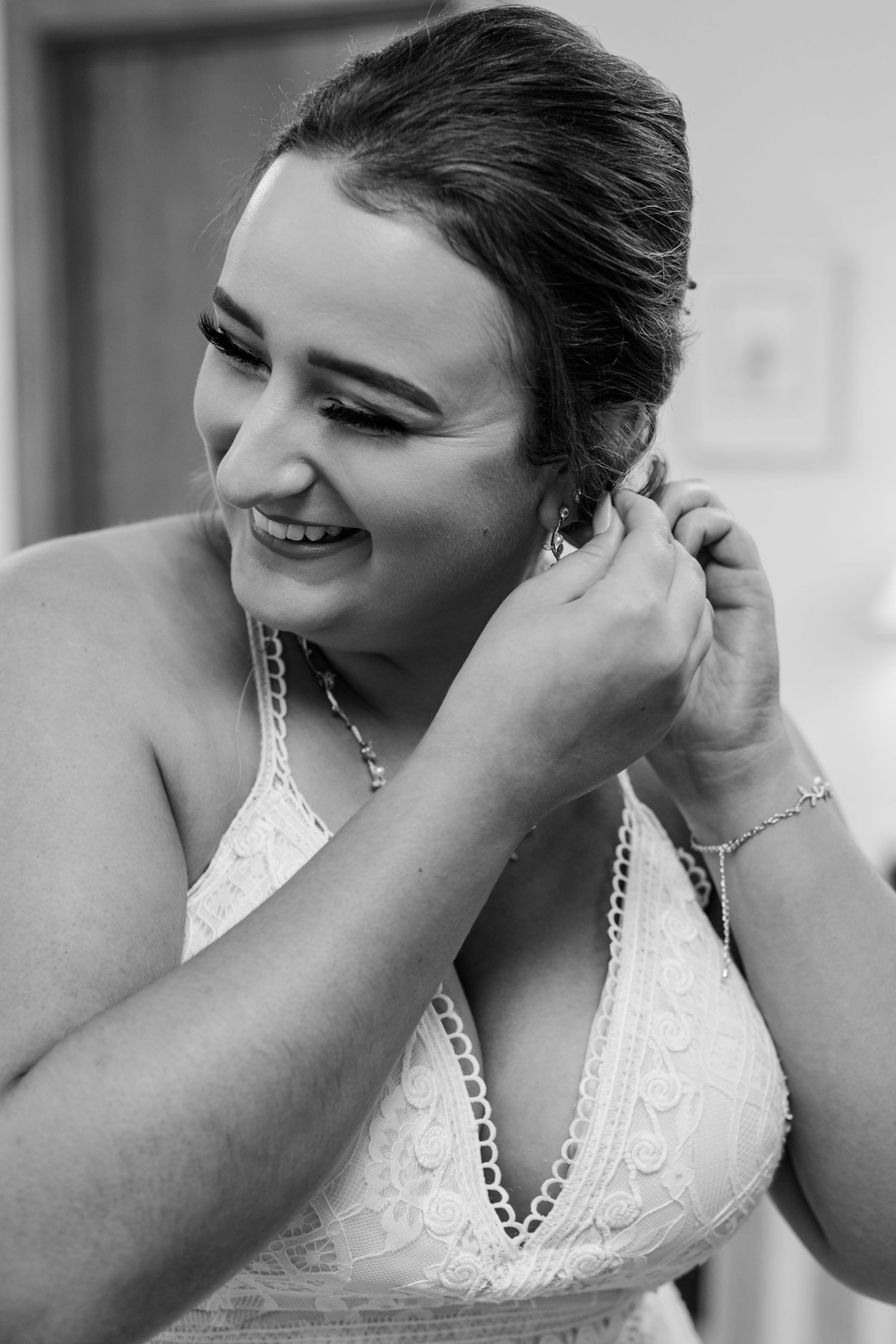 Close-up shots of a bride putting on earrings before her wedding ceremony.
