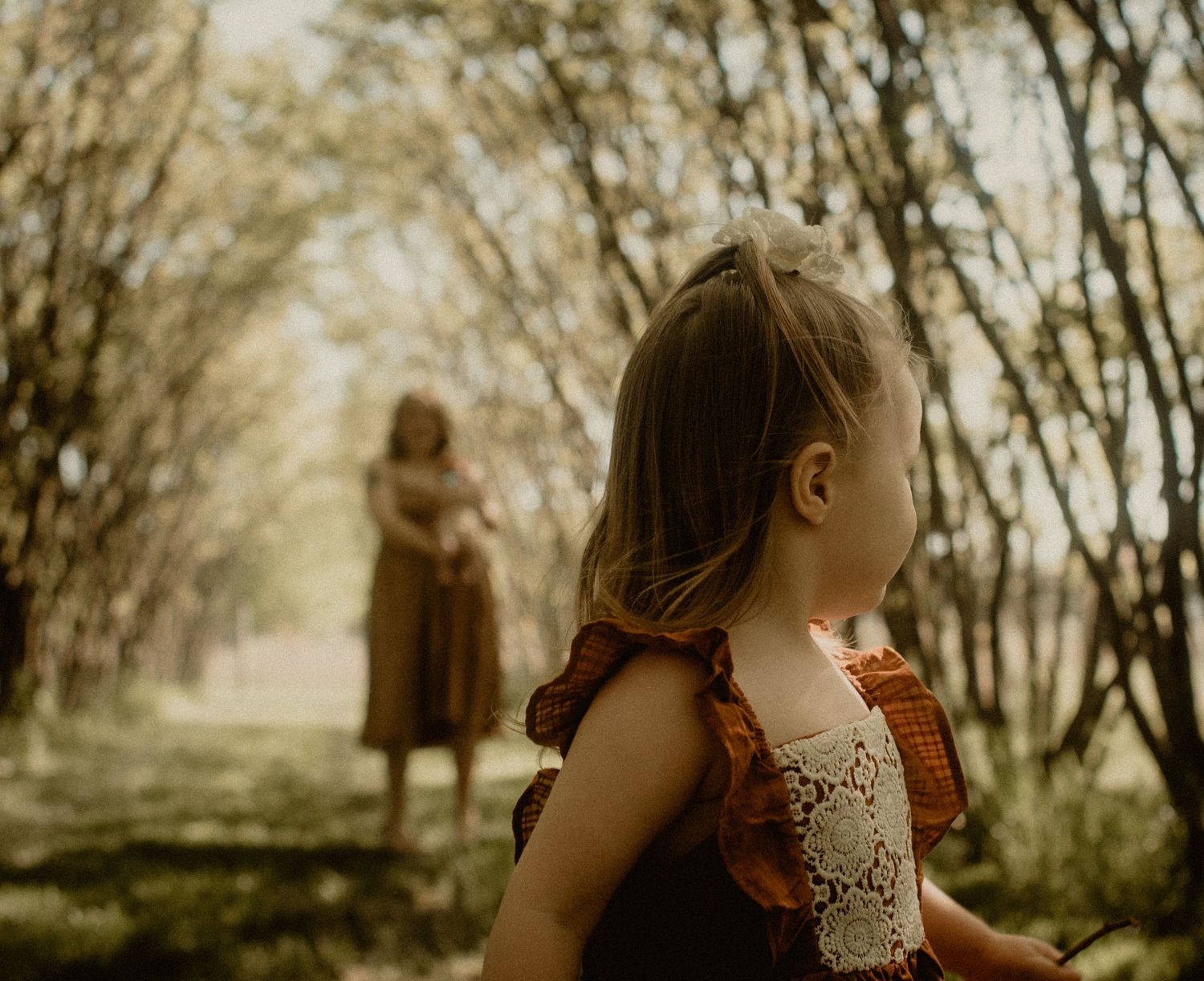 Toddler dancing around mom in the background