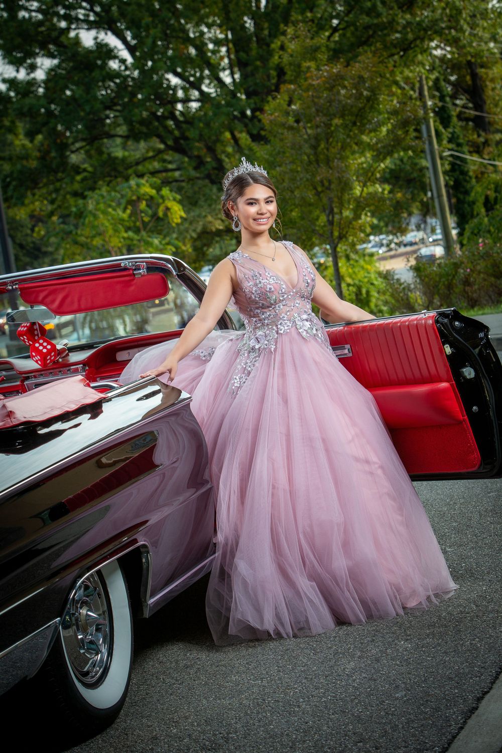Pink tulle ballgown with beaded bodice next to vintage black convertible car.