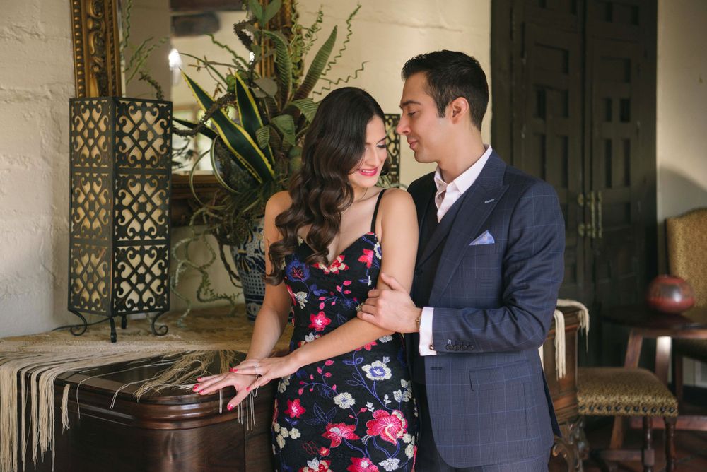 couples standing next to a piano in a engagement session