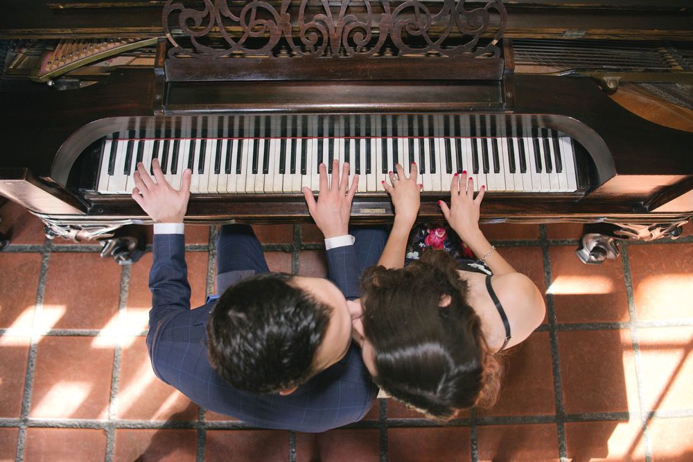 beautiful couple kissing and playing the piano
