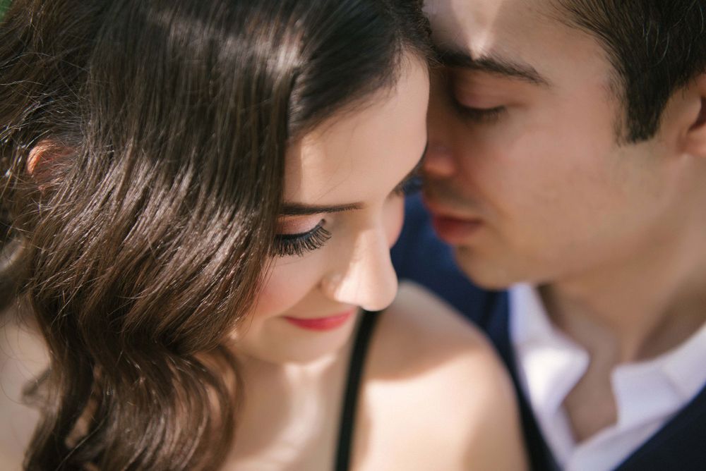 couple whispering to each other at the engagement session
