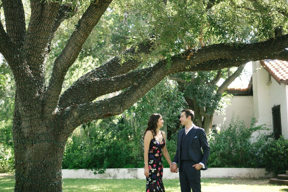 couple standing next to a tree