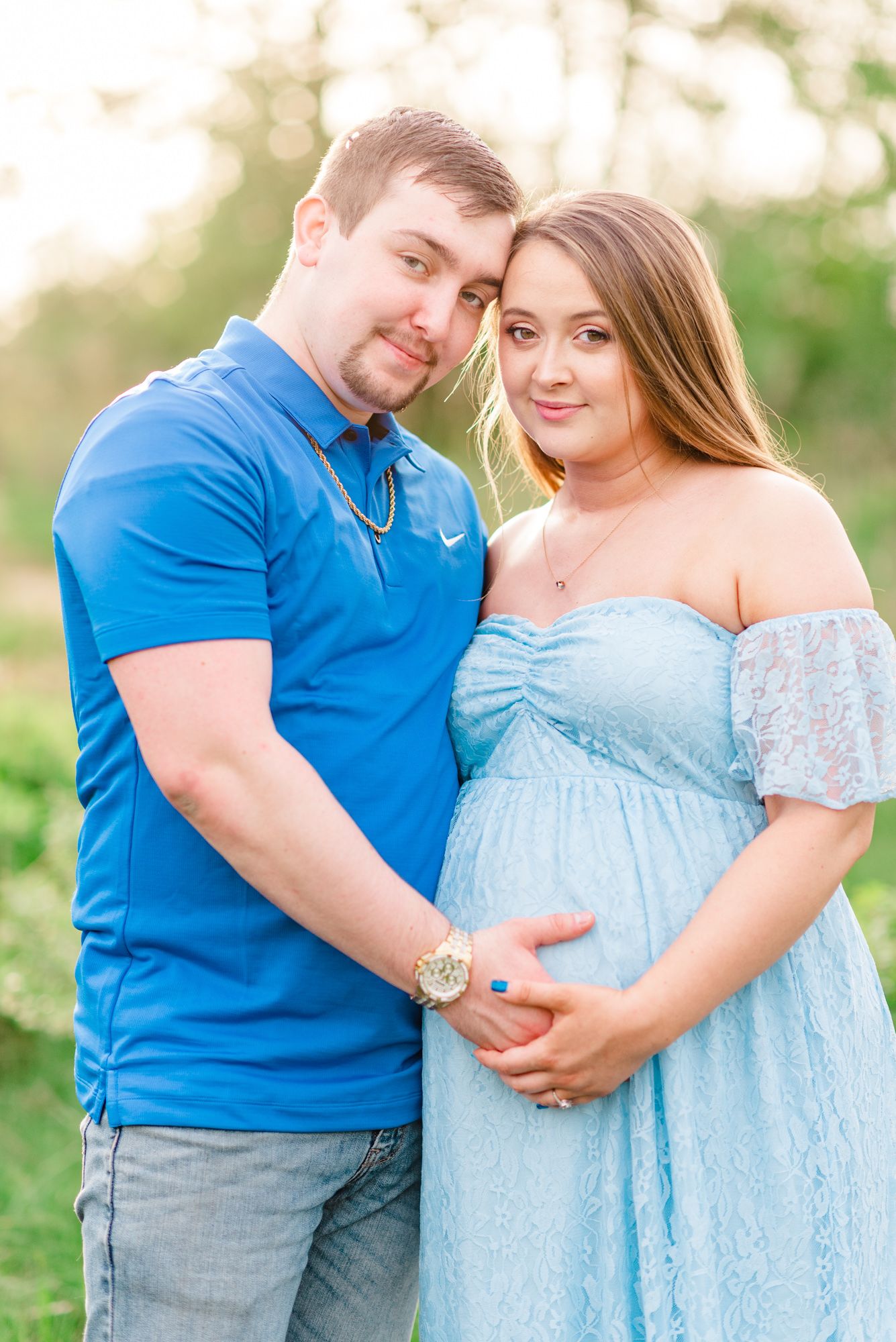 Maternity session with couple in field in golden hour sunlight at Moraine State Park, Pennsylvania