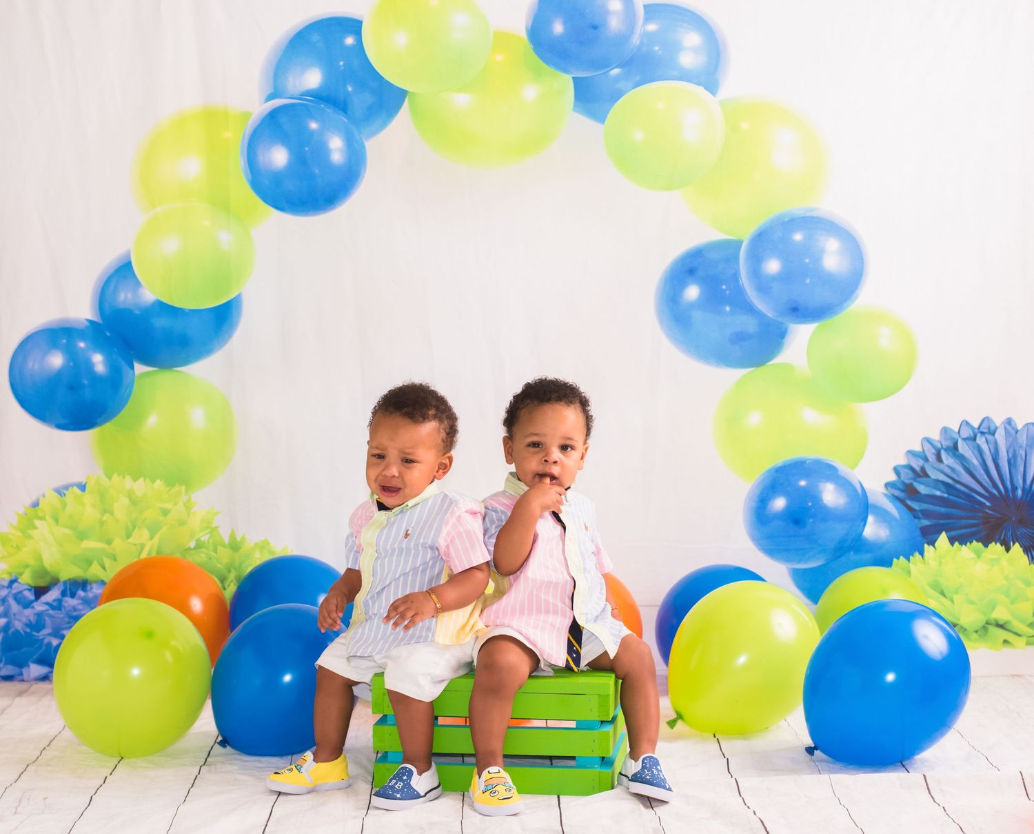 Colorful balloon arch with blue and lime green balloons creating a festive atmosphere.
