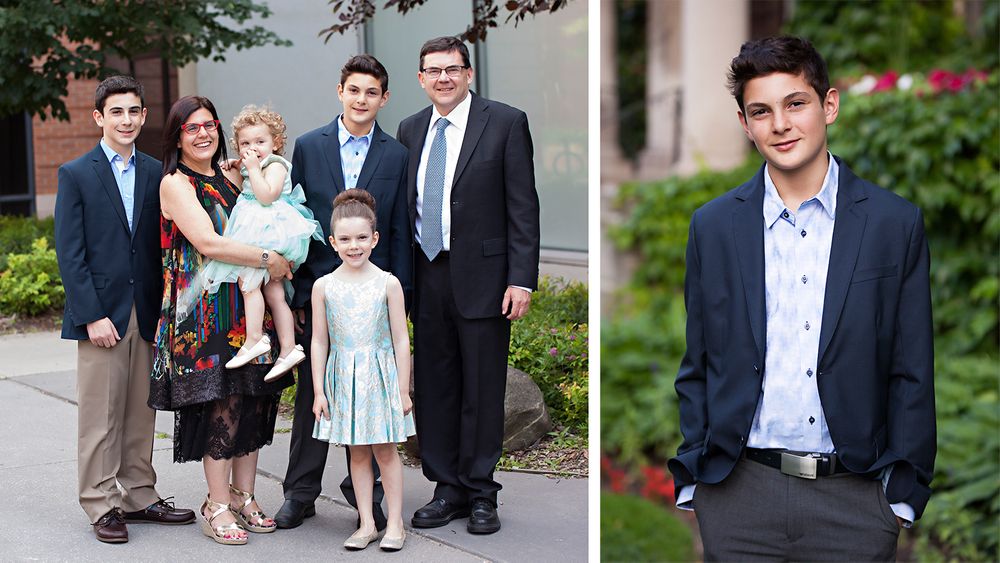 A formal family photo taken outdoors with trees and buildings in the background.