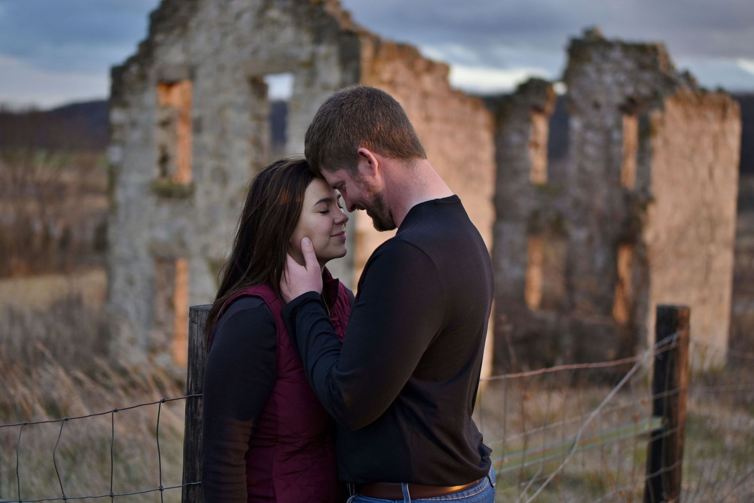 A romantic photoshoot series featuring a couple posing against stone ruins at sunset.