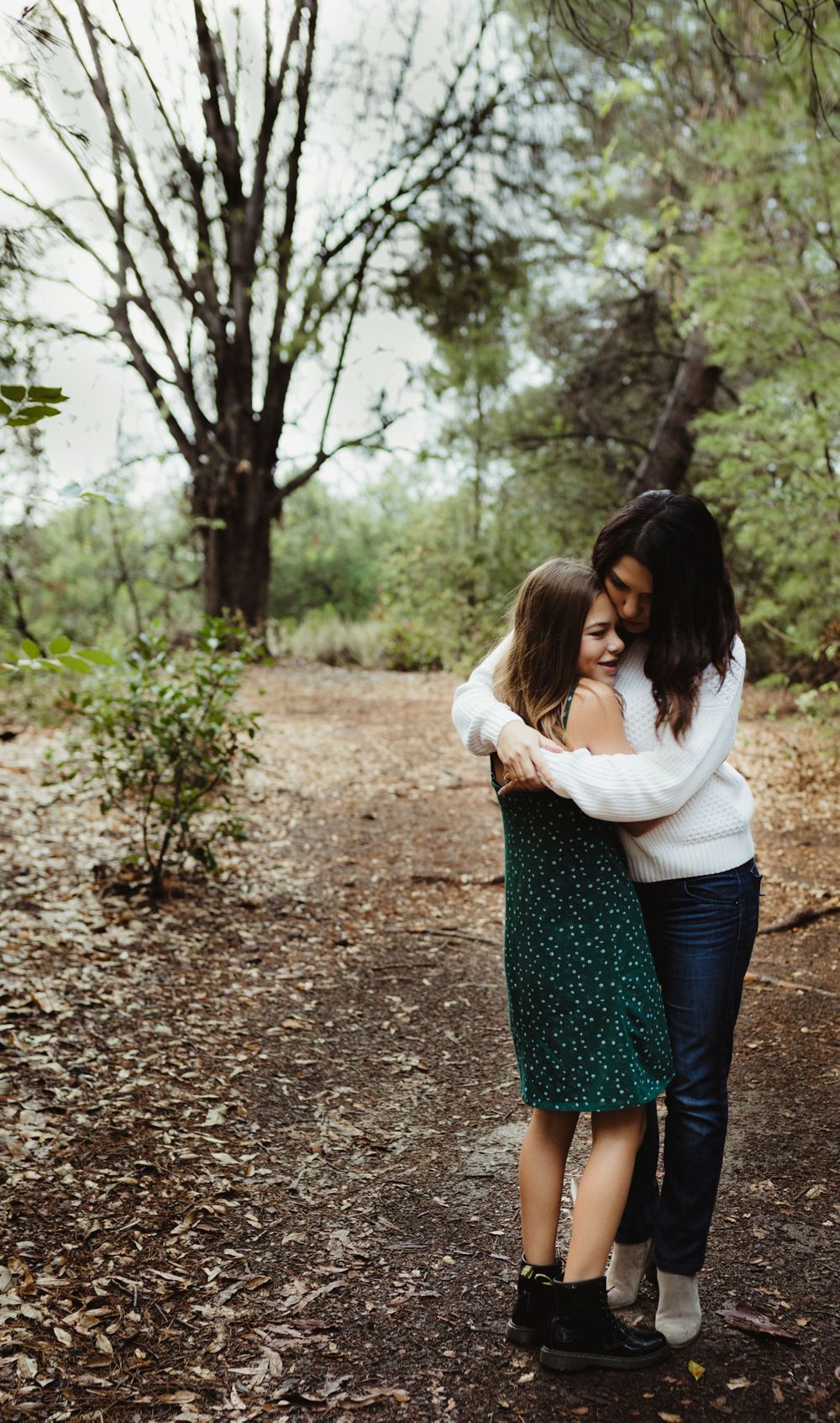 Eden Prairie family photographer | Mom-and-daughter-standing-on-dirt-with-trees-around-them-with-arms-around-each-other