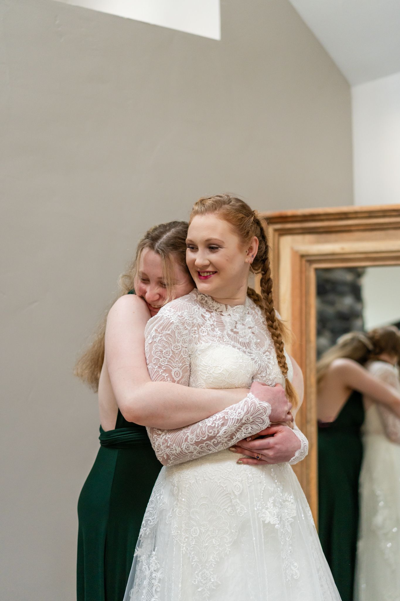 bride and sister embrace