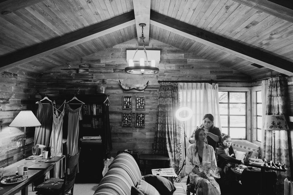 Interior of log cabin with wooden beams and vintage furnishings.