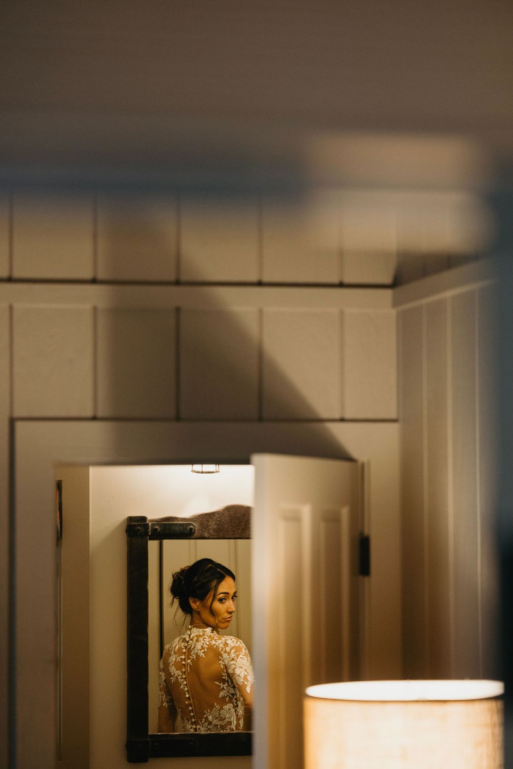 Dramatic lighting creates shadows and silhouettes in minimalist interior space.