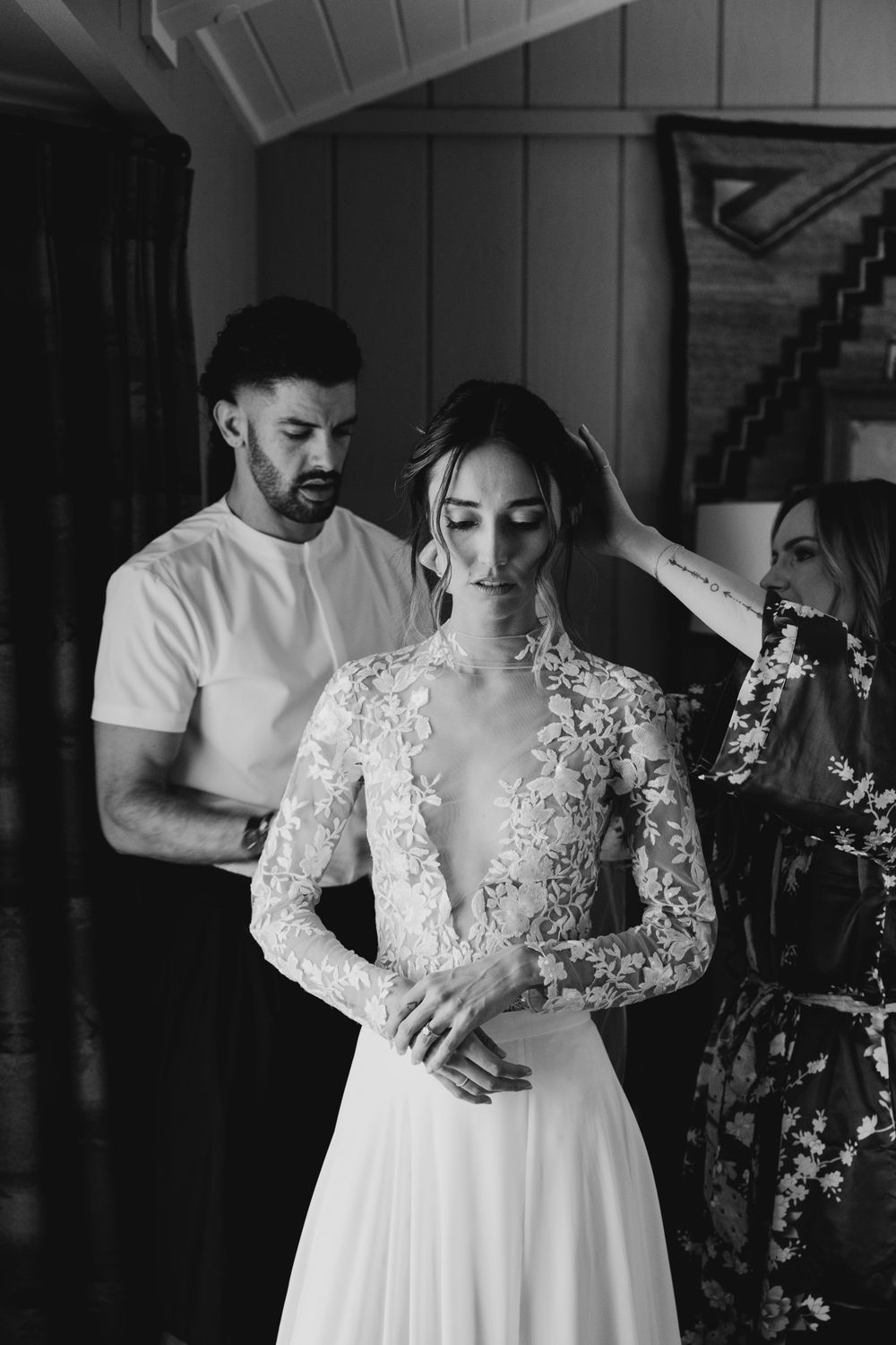 Intimate getting ready moment with delicate lace wedding dress details.