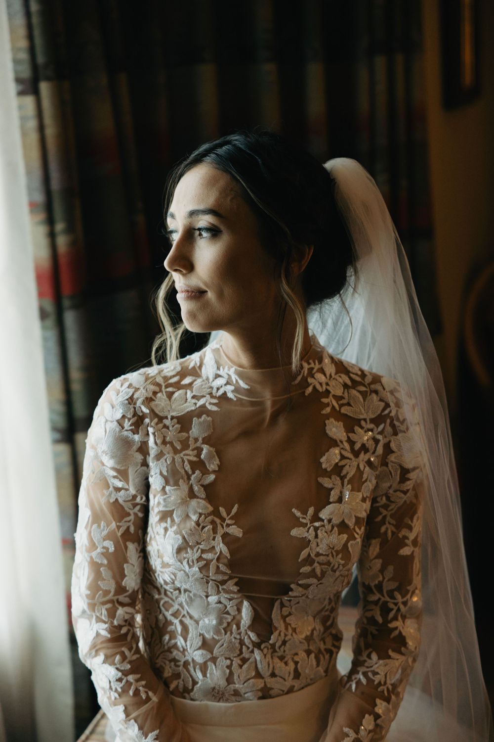 Elegant bridal portraits featuring intricate lace details and flowing veil in natural light.