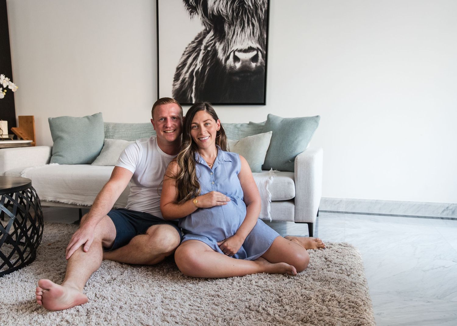 at-home maternity photoshoot, parents sat on floor posing
