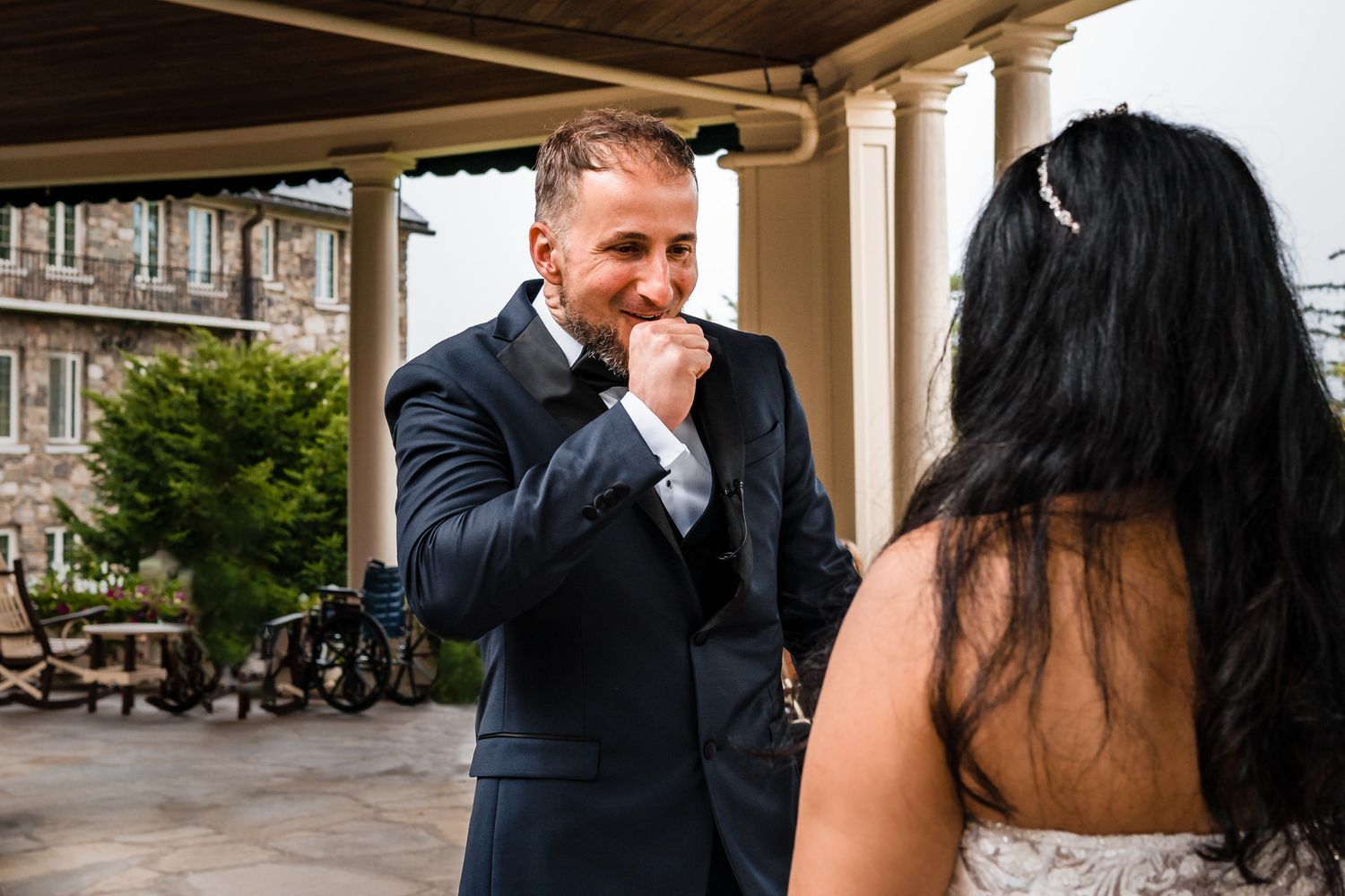 A romantic engagement photo session captured against a backdrop of elegant columns and architecture.