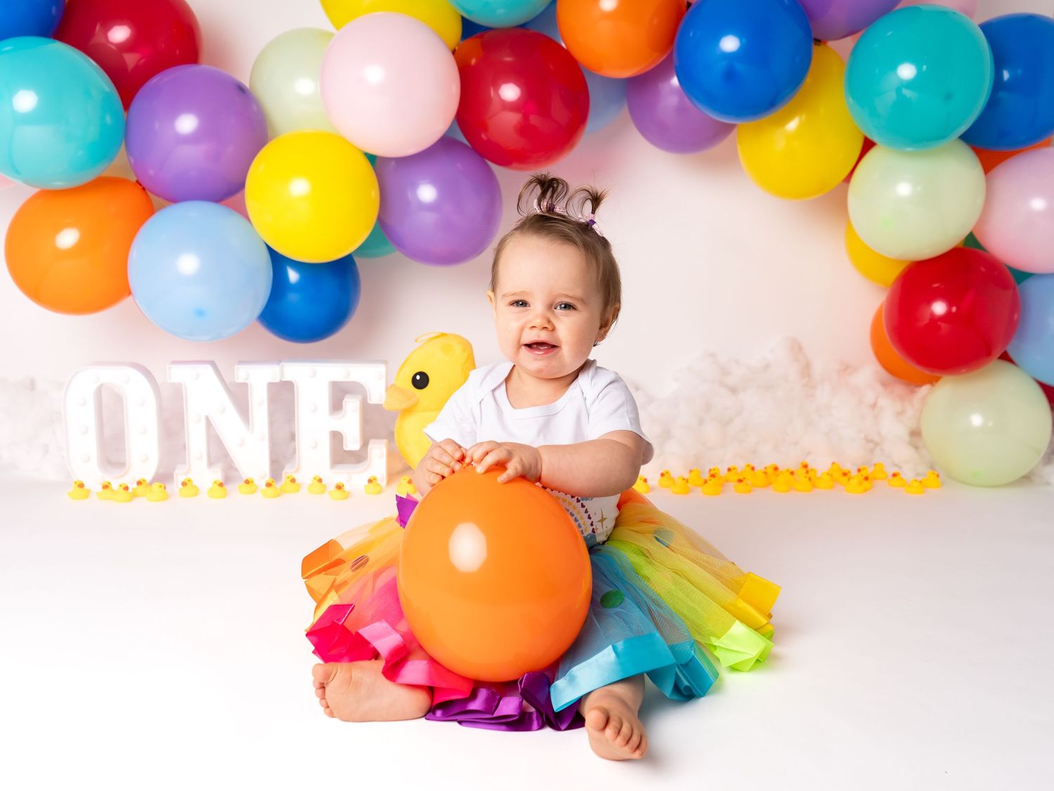 Girls first birthday cake smash rainbow duck theme at doncaster studio with client of Heather Katie Photography.
