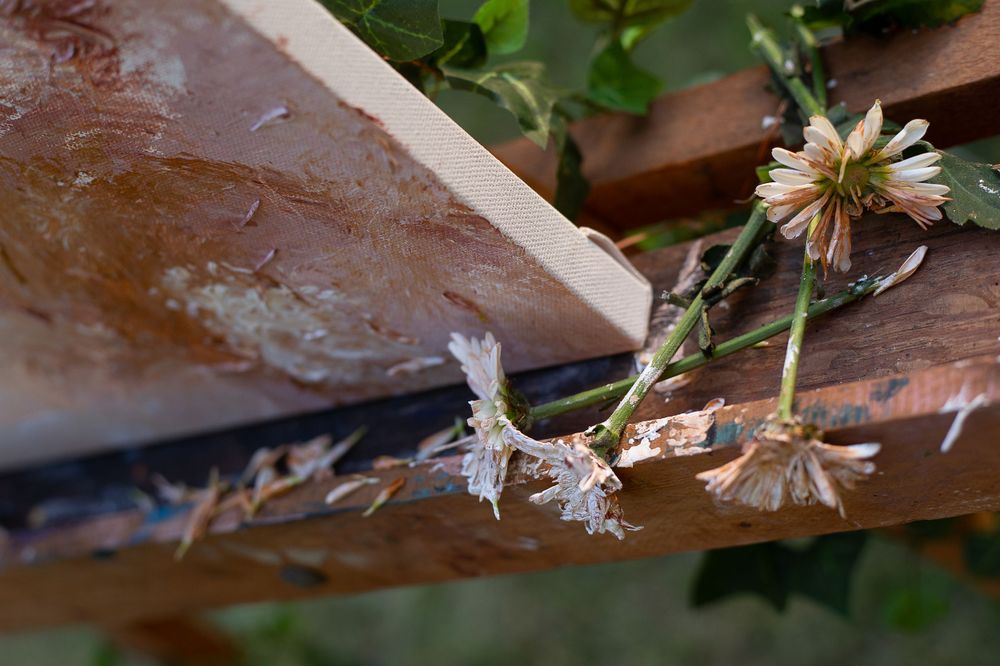 Close-up view of dried flowers against rustic wooden beams.
