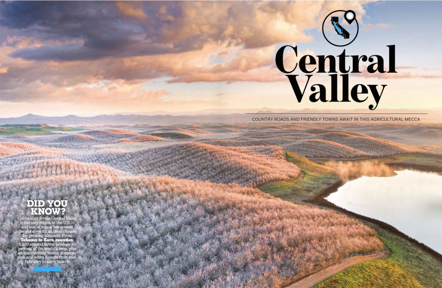Aerial view of Central Valley vineyards and orchards along a winding river under dramatic sunset clouds.