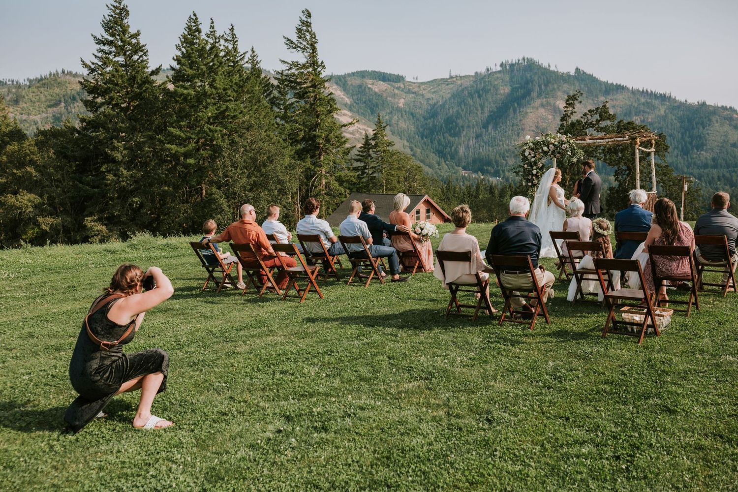 Photographer taking a picture at a wedding ceremony in Hood River with bride and groom at the altar