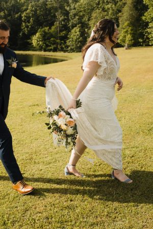 Close-up shots of feet on grass showing a white wedding dress and orange shoes.