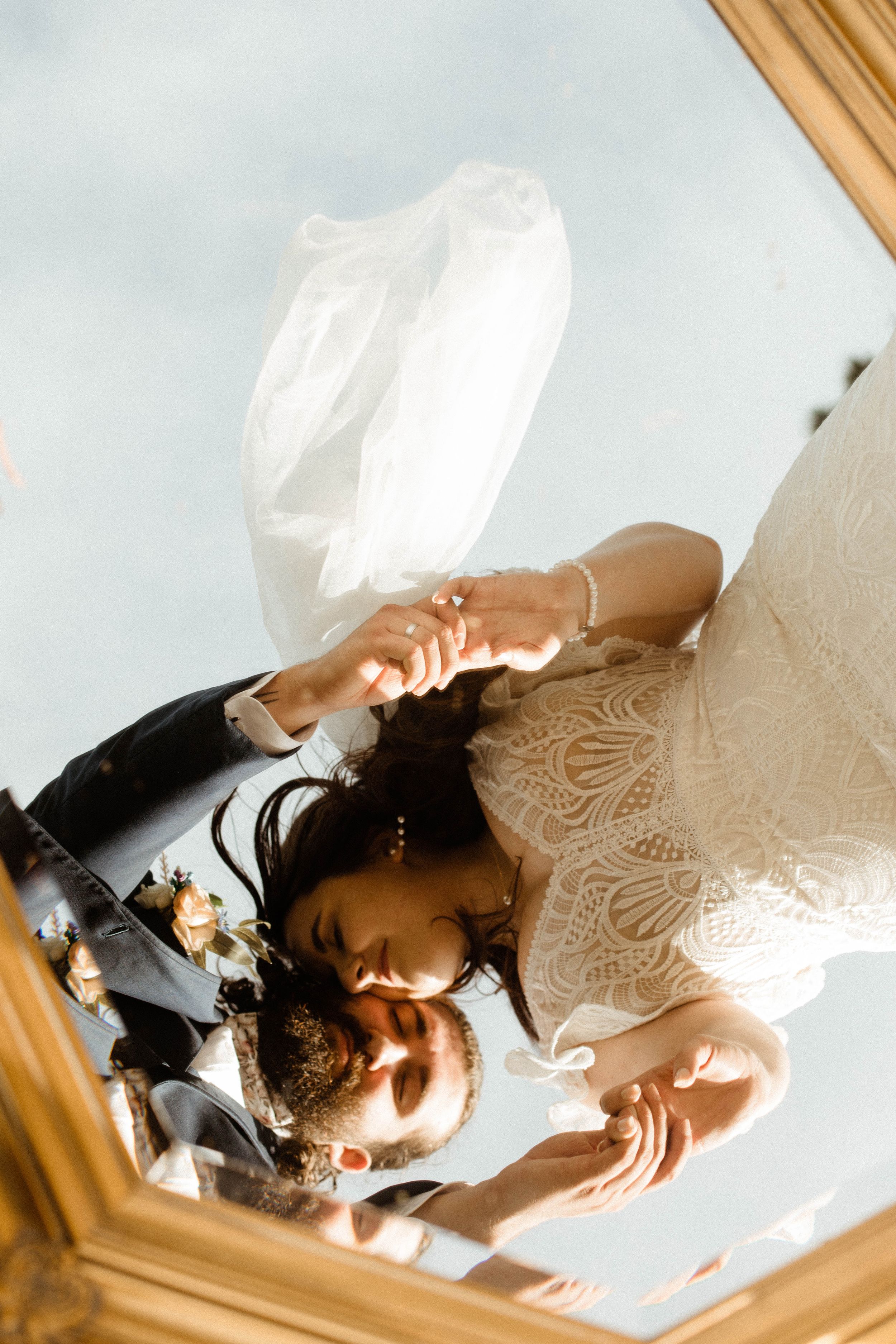 Artistic overhead view through white lace fabric creating a dreamy bridal portrait.