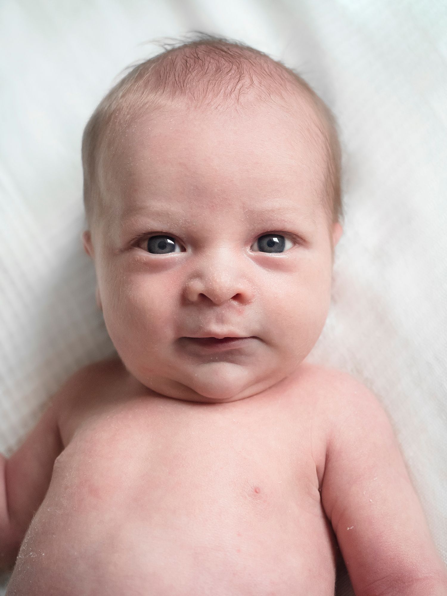 baby starting to smile while looking at camera