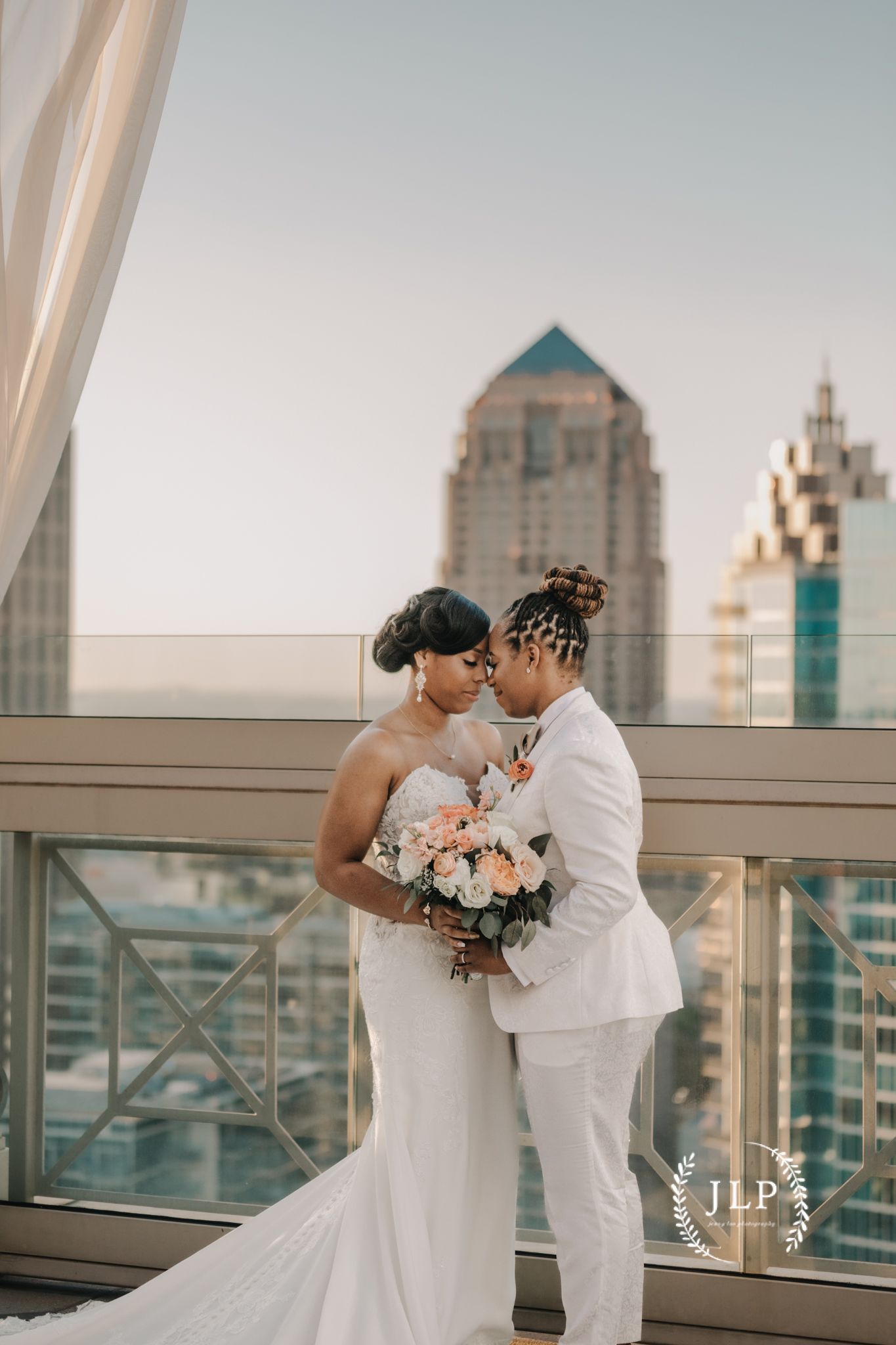 Urban rooftop wedding photos with city skyline backdrop and floral bouquet.